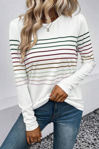 a woman wearing a white and green striped top