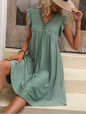 a woman sitting on a step wearing a hat