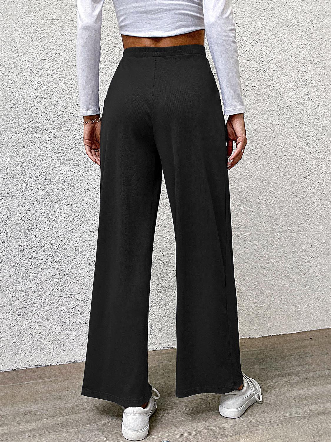 a woman in a white shirt and black pants