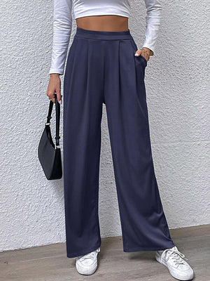 a woman in a white top and blue pants