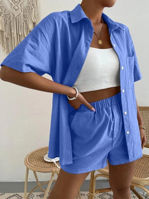 a woman wearing a blue shirt and shorts