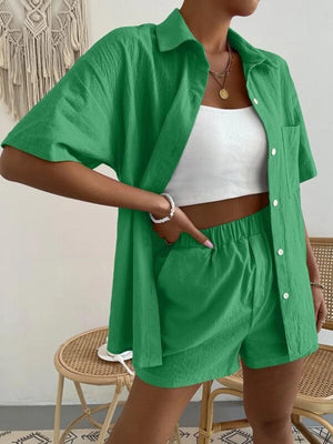 a woman wearing a green shirt and shorts