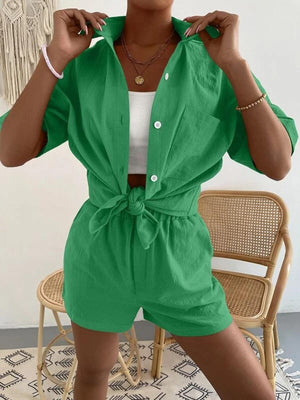 a woman wearing a green shirt and shorts