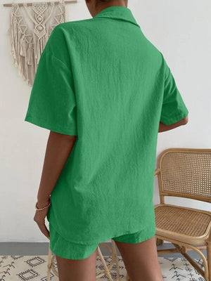 a woman wearing a green shirt and shorts