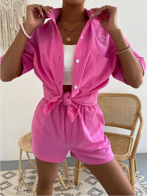 a woman wearing a pink shirt and shorts