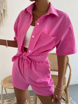 a woman wearing a pink shirt and shorts
