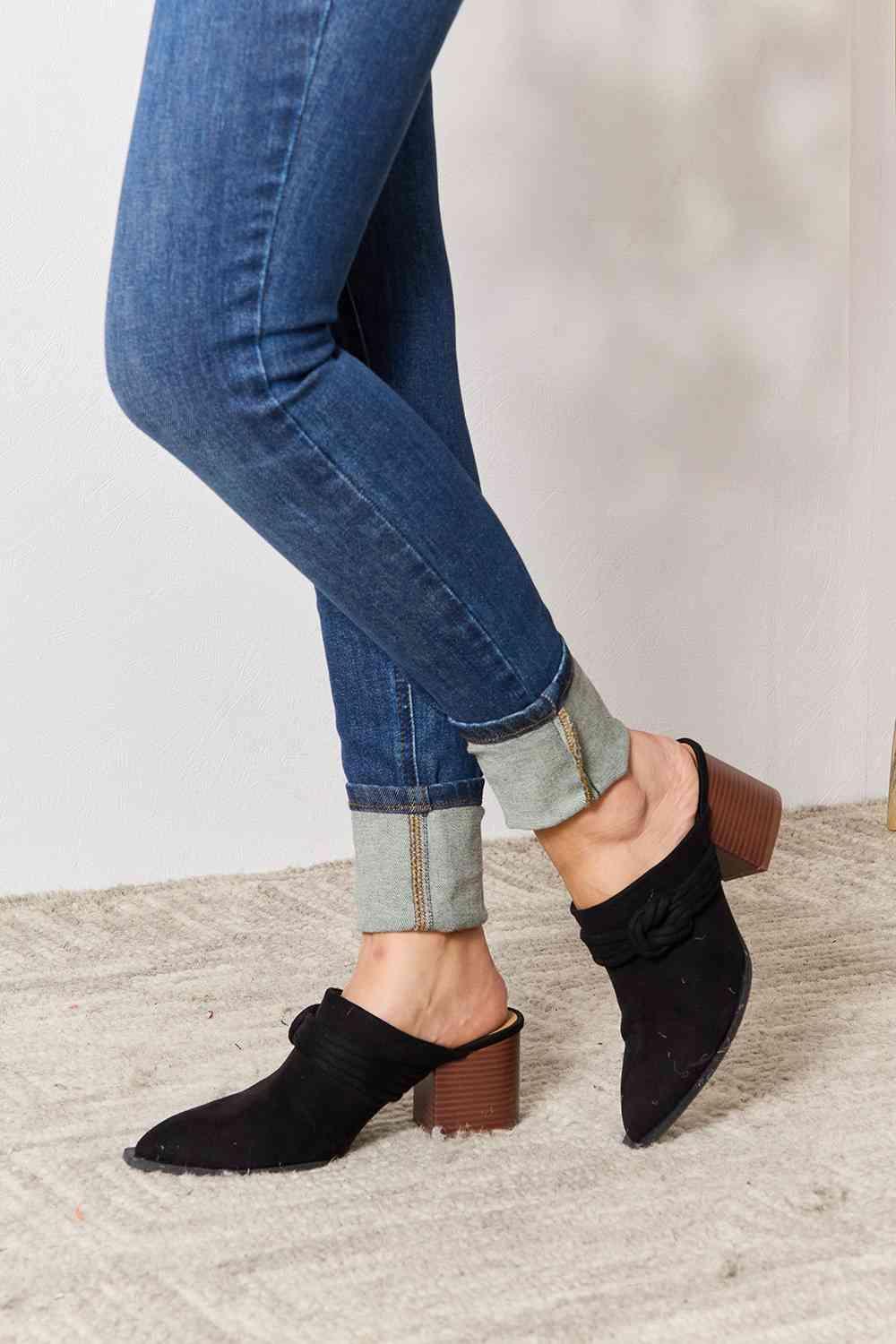 a close up of a person's feet wearing black shoes