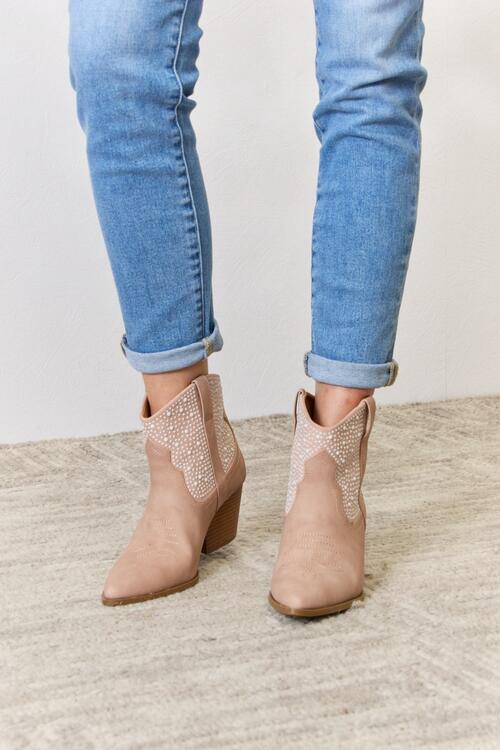 a close up of a person wearing a pair of boots