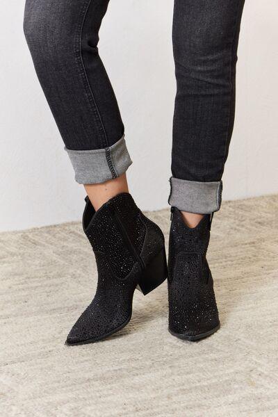 a close up of a person wearing black boots