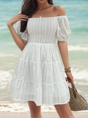 a woman in a white dress on the beach