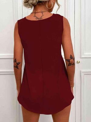 a woman wearing a red dress with a star tattoo on her arm