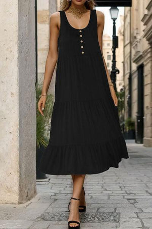a woman in a black dress walking down a street