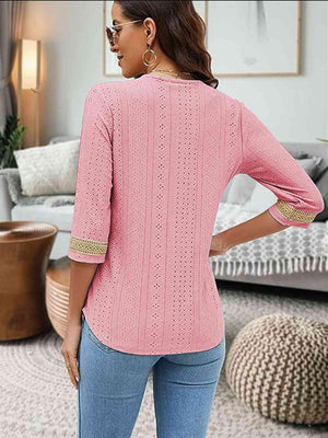 a woman wearing a pink sweater and jeans