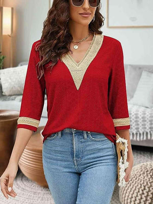 a woman wearing a red top and jeans