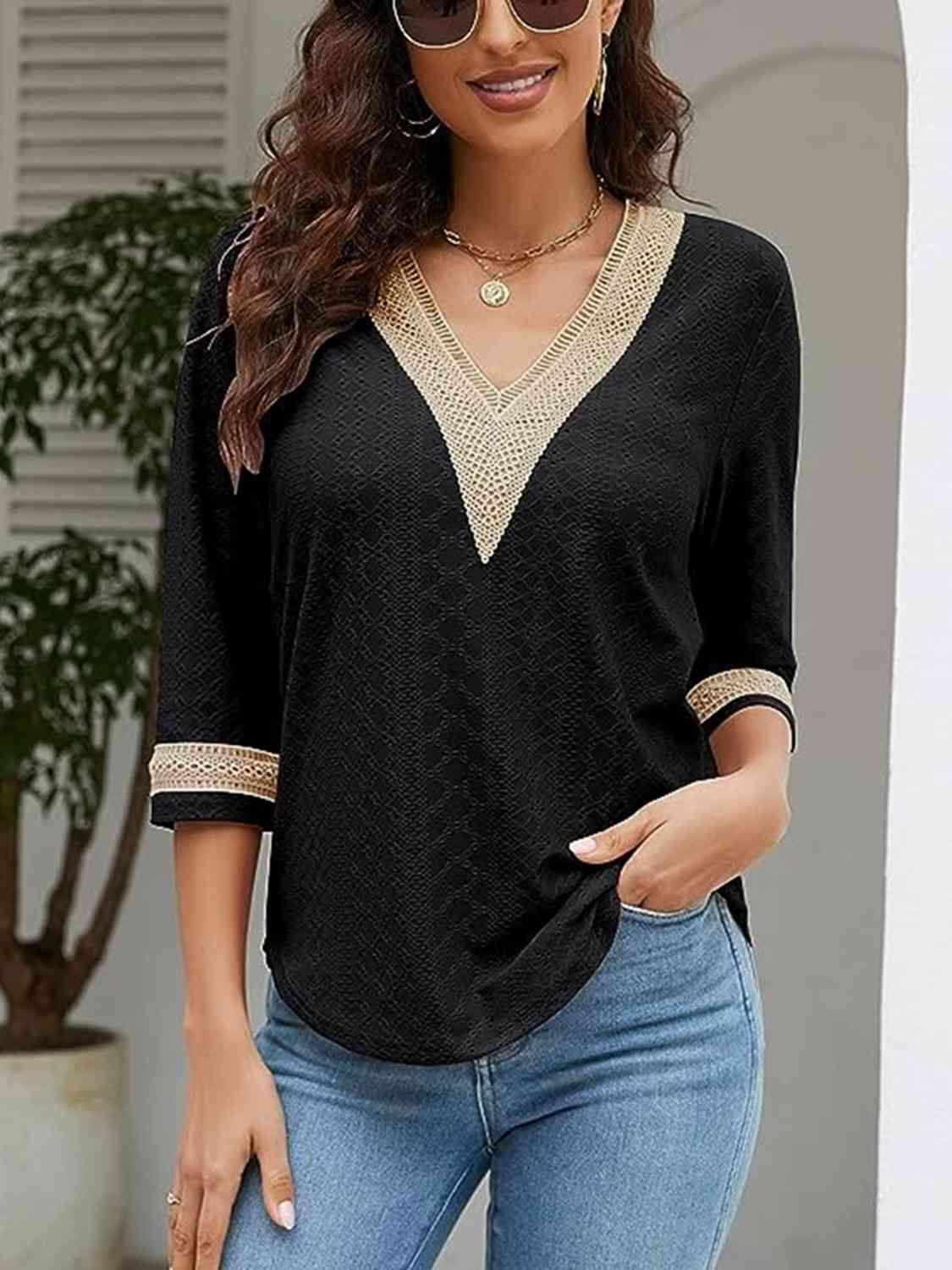 a woman wearing a black top and jeans