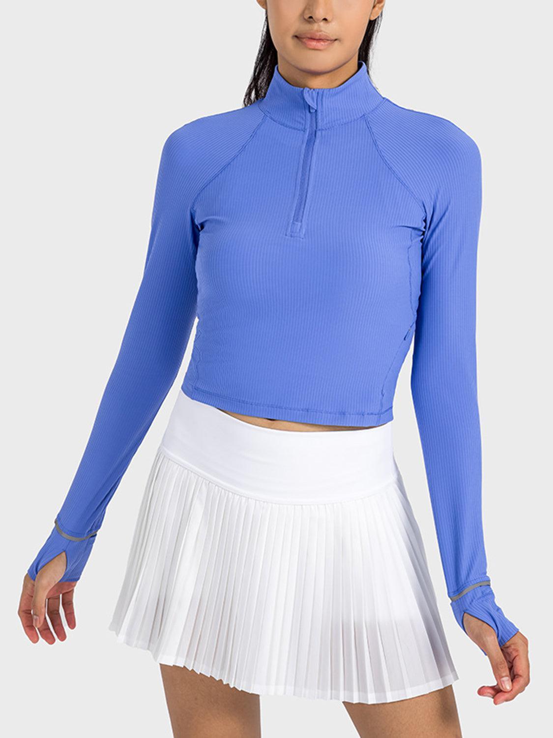 a woman in a blue top and white skirt