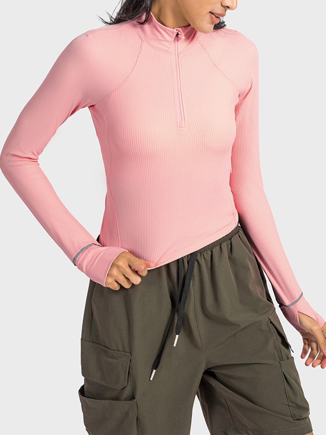a woman wearing a pink top and cargo shorts