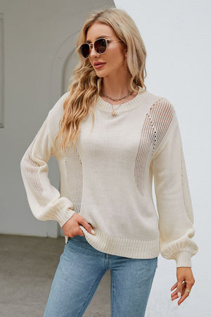 a woman wearing a white sweater and jeans