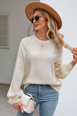 a woman wearing a white sweater and jeans