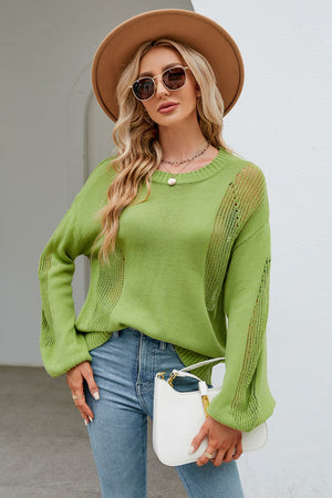 a woman wearing a green sweater and jeans