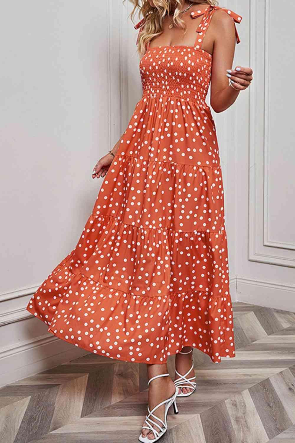 a woman in an orange polka dot dress