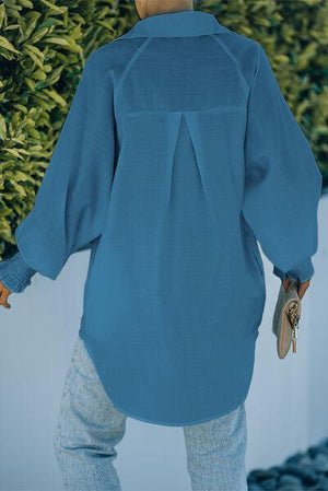 a woman wearing a blue shirt and jeans