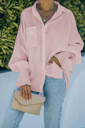 a woman wearing a pink shirt and jeans