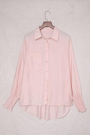 a pink shirt hanging on a hanger