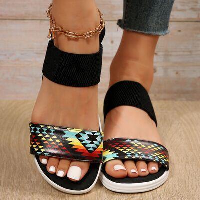a close up of a person's feet wearing sandals
