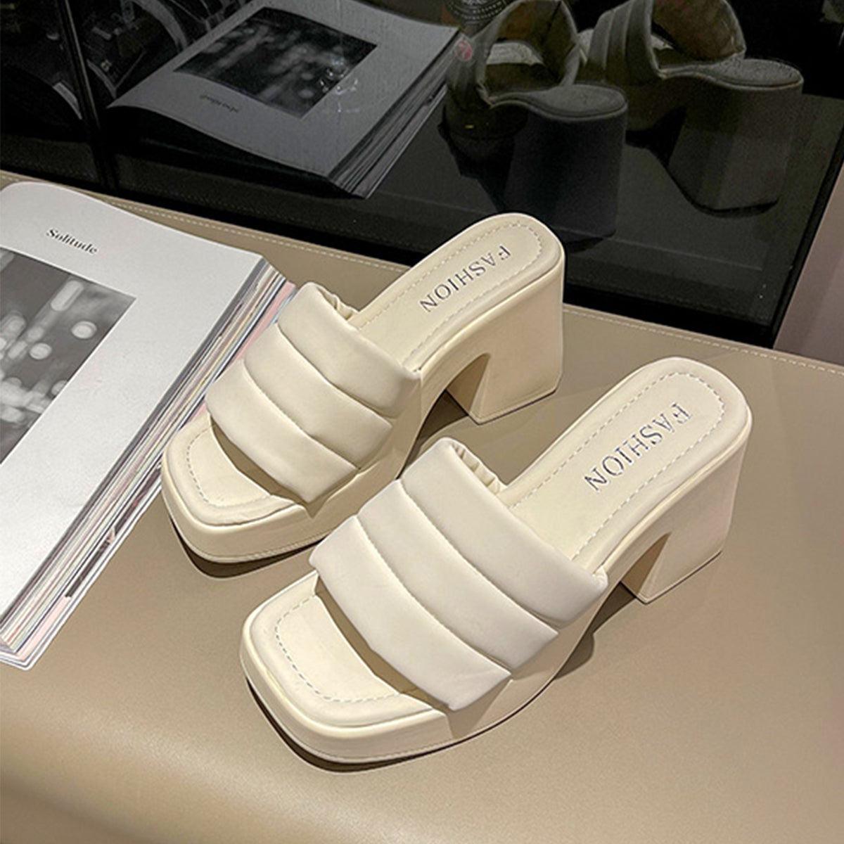 a pair of white shoes sitting on top of a table