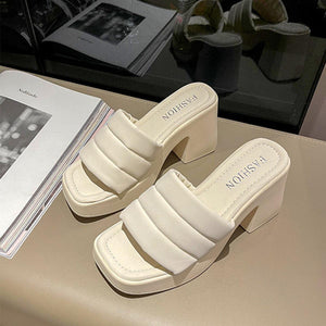 a pair of white shoes sitting on top of a table