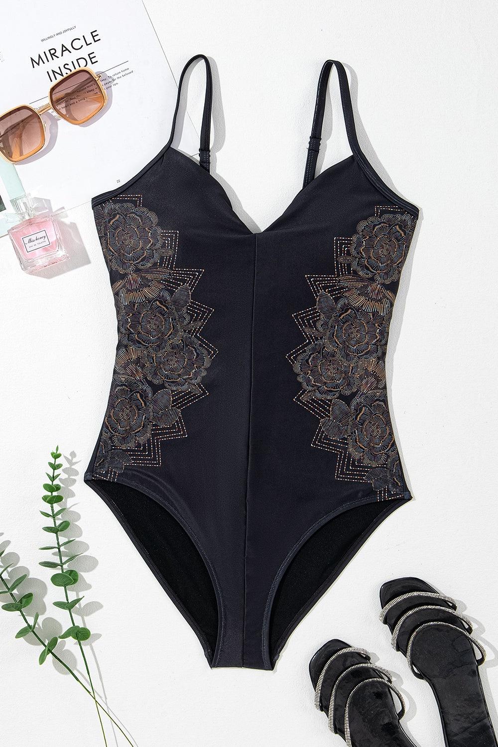 a woman's swimsuit with a pair of black sandals