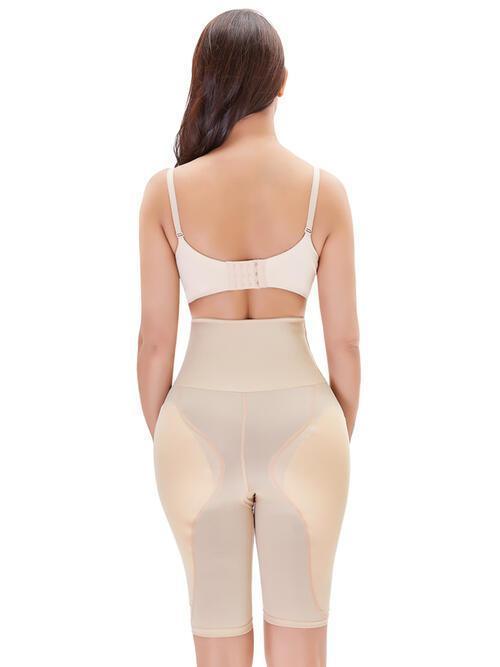 a woman wearing a beige bodysuit with a high waist
