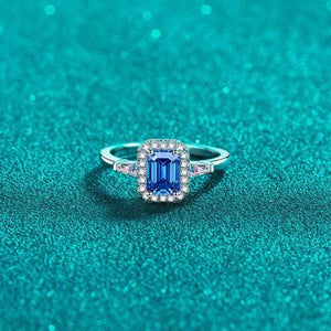 a ring with a blue stone surrounded by diamonds