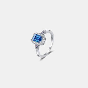 a white gold ring with a blue topazte and diamonds
