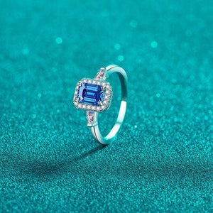 a ring with a blue sapphire and diamonds