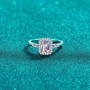 a diamond ring sitting on top of a blue surface