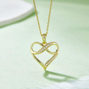 a gold necklace with a heart shaped pendant