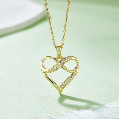a gold necklace with a heart shaped pendant