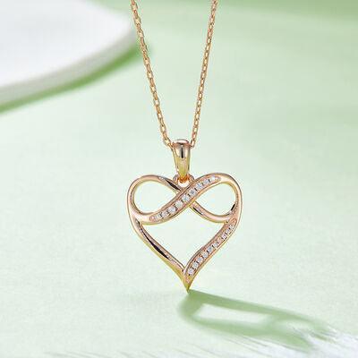 a gold necklace with a heart shaped pendant