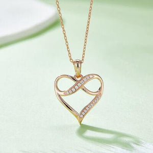 a gold necklace with a heart shaped pendant