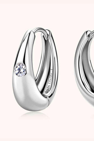 a pair of silver hoop earrings with a diamond