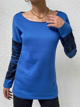 a woman wearing a blue shirt and black pants