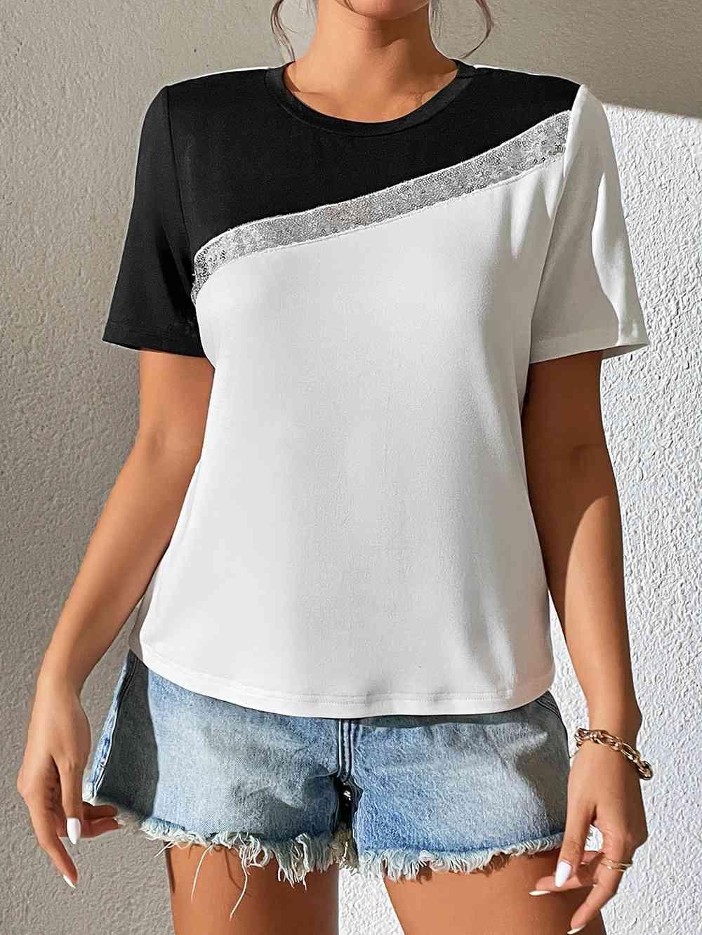 a woman wearing a black and white top