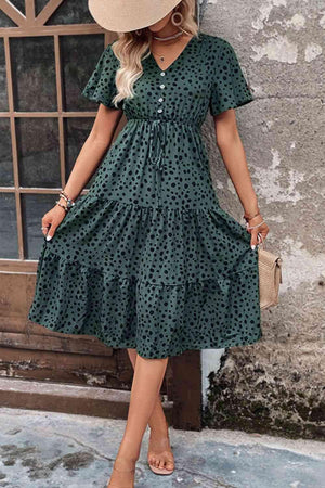 a woman wearing a green polka dot dress