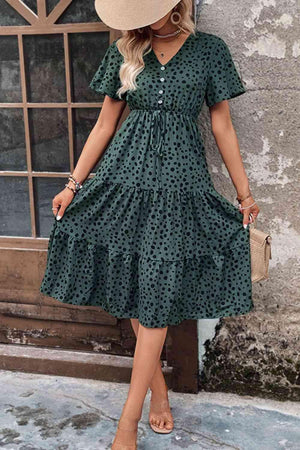 a woman wearing a green polka dot dress
