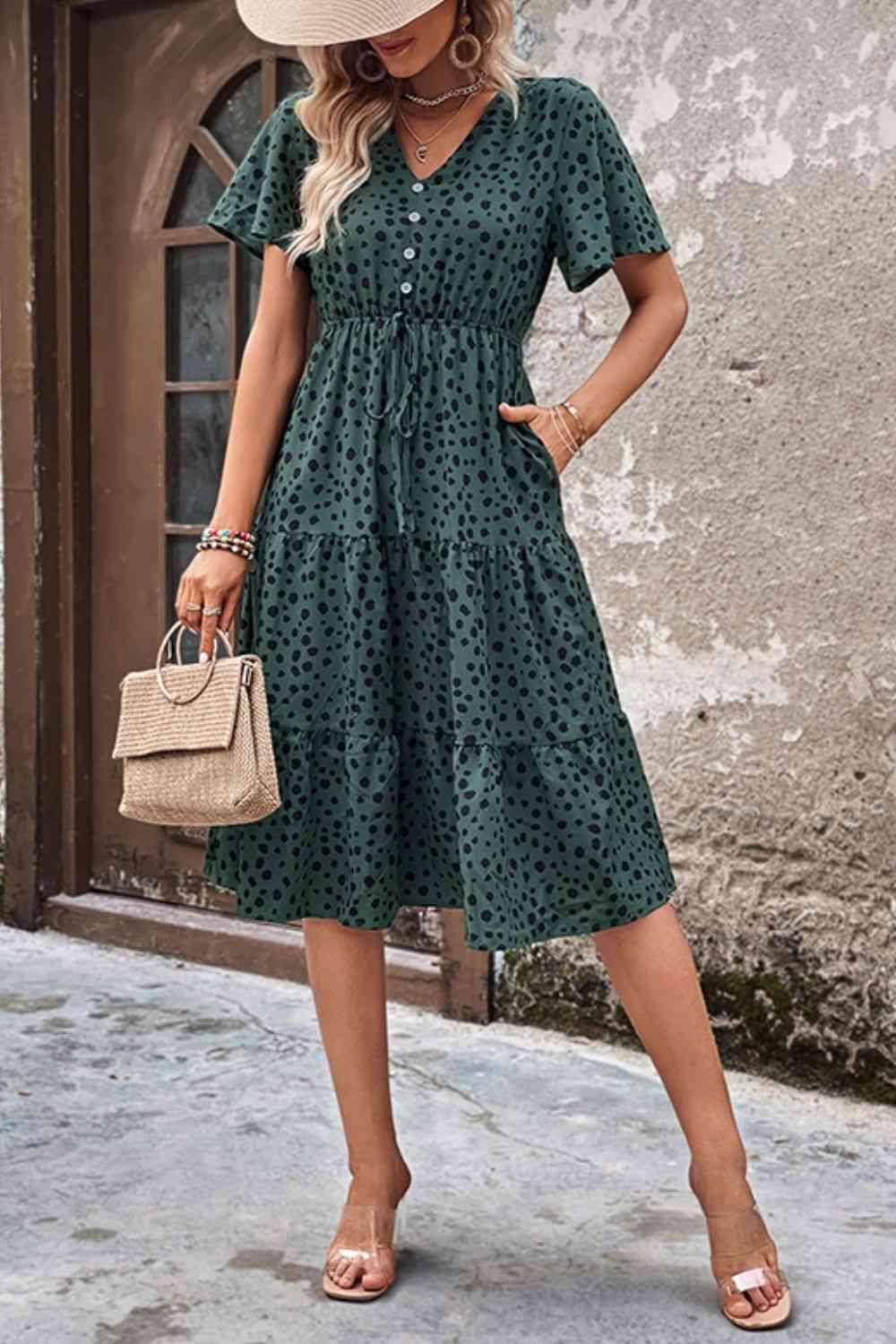 a woman wearing a green dress and hat