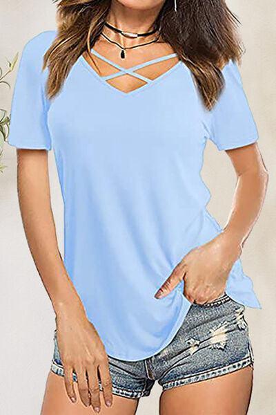 a woman wearing a blue shirt and denim shorts