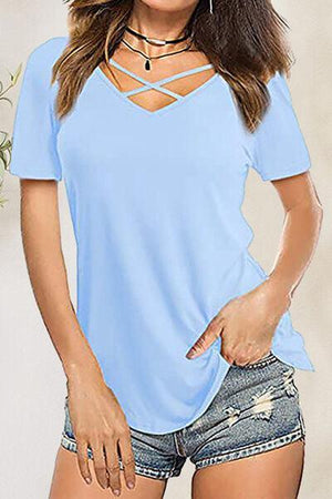 a woman wearing a blue shirt and denim shorts