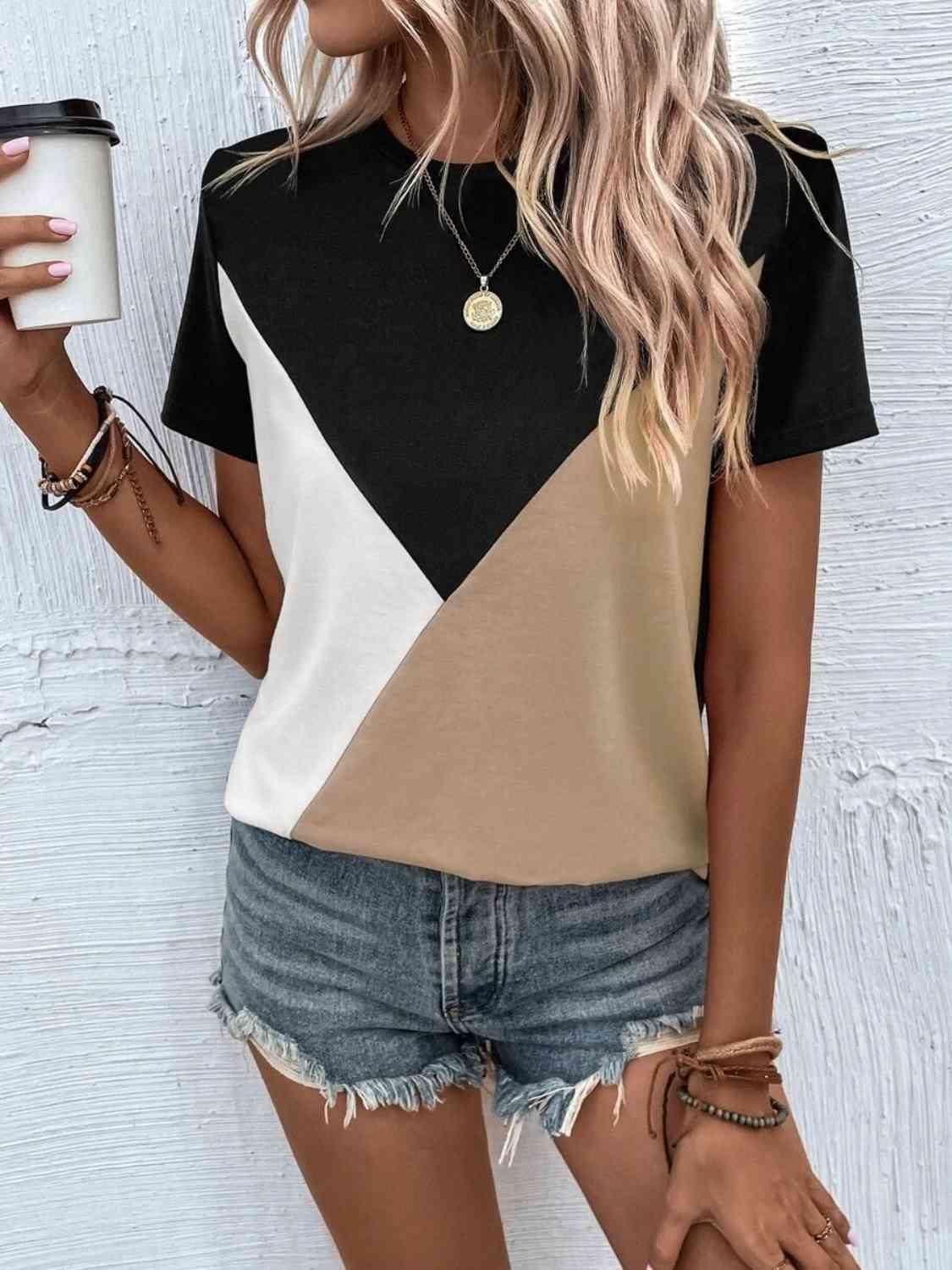 a woman holding a cup of coffee and wearing a black and white shirt